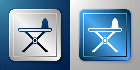 White Electric iron and ironing board icon isolated on blue and grey background. Steam iron. Silver and blue square button. Vector