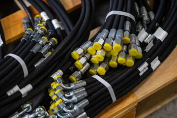 Bundle of new high pressure hydraulic hoses in a package. Hydraulic hoses with yellow plugs