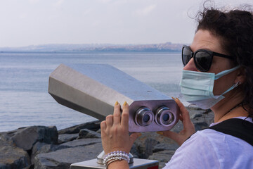 Observation deck and binoculars with a view of the sea and the city of Istanbul