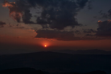 sun setting over the horizon at sunset