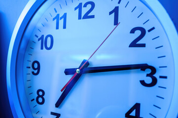 Close-up of generic wall clock with 7 hours 14 minutes time showing