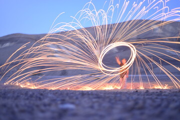 Iron wool circle drawing light fireworks. Burning Steel Wool spinning, Trajectories of burning...