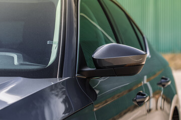 Close up front view of car side mirror. Front rear view mirror on the car window. Car exterior...