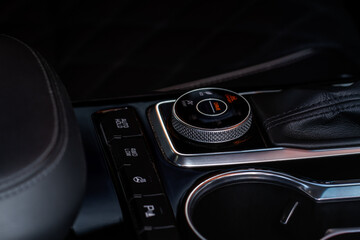 Fototapeta na wymiar Drive selector button. Car interior, offroad drive controller closeup view. Wheel drive selection. Four-Wheel Drive transmission selection system..