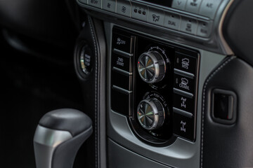 Drive selector button. Automatic gear lever and gear shift. Car interior, offroad drive controller closeup view. Wheel drive selectiob. Four-Wheel Drive transmission selection system.