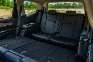 Modern SUV car inside. Leather black back passenger seats in modern luxury car. Comfortable leather seats.