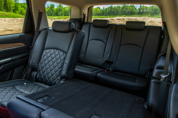 Modern SUV car inside. Leather black back passenger seats in modern luxury car. Comfortable leather seats.