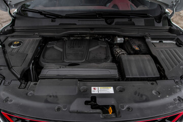SUV car with open hood. Car engine. Car engine and parts under hood bonnet
