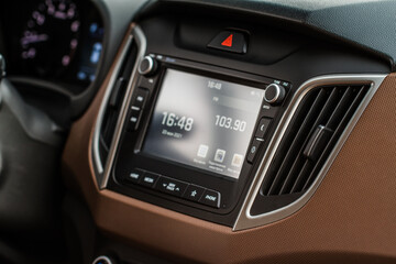 Obraz na płótnie Canvas Modern car media display in the interior of the car. Touchscreen monitor on the dashboard of the modern car.