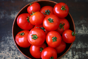Fresh juicy tomatoes in a bowl.