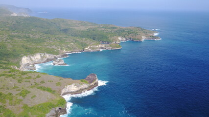 Naklejka premium drone view coast beach sea ocean waves nature island Nusa Penida Bali Indonesia summer travel explore blue 