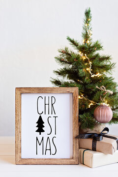 Christmas background with wooden picture frame with text christmas and decoration. Winter holidays celebration concept with copy space for text.