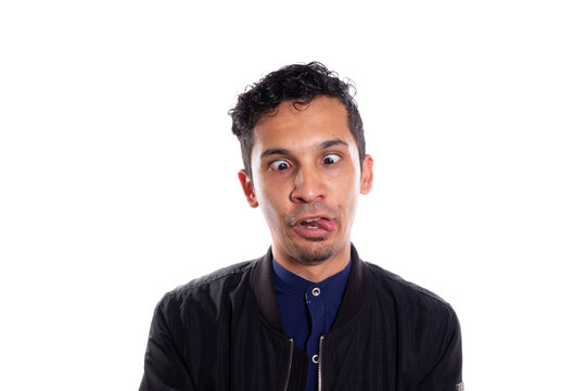 Crazy man sticking out his tongue, isolated on white background. Young adult young visco with crazy expression.