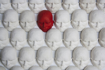 Red individual in the crowd. Concept of leadership, excellence, difference and identity.