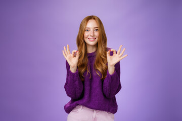 Girl loves her new haircut showing okay gesture with both hands and smiling delighted, feeling happy and satisfied, posing in purple outfit over violet background pleased with perfect customer service