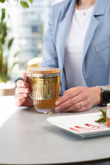 Girl enjoing homemade Traditional Austrian strudel with cherry or red berries and powdered sugar with cup of tea. Menu for cafe. Bright background.
