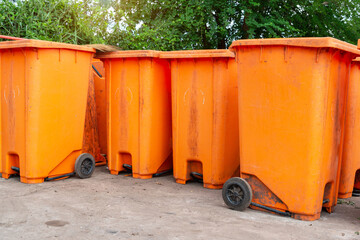  Orange rubbish bin in a public place. essential equipment to keep the environment clean and comfortable, Orange Plastic Waste Container Or Wheelie Bin.
