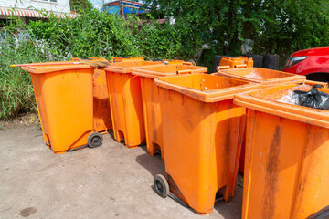  Orange rubbish bin in a public place. essential equipment to keep the environment clean and...
