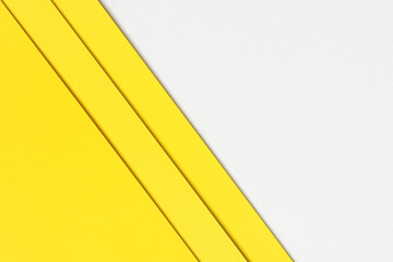 Yellow paper sheets are stacked on top of a blank white paper in this abstract background concept, which is suitable for usage as a design element or a website cover ideas.