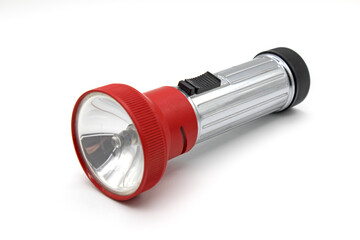 Vintage metal red flashlight torch, made in Yugoslavia, isolated on a white background - obrazy, fototapety, plakaty