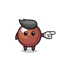 chocolate ball mascot with pointing right gesture