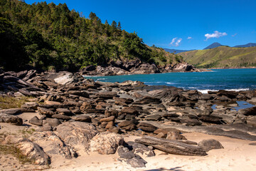 Sea waves lash line impact rock on the beach in Brazil