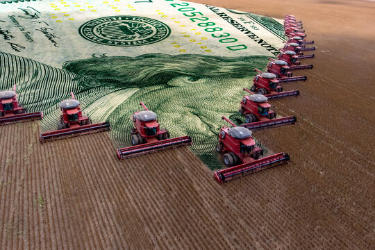 Mass soybean harvesting at a farm in Mato Grosso state,Brazil. Concept commodities with agribusiness, and dollar banknote.