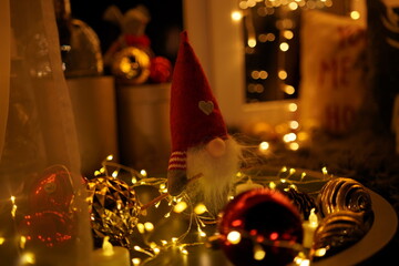 New Year 2021 interior with candles, bulbs and bokeh. Room decorated to christmas celebration. Christmas tree with presents
