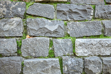 The wall is made of stone. Masonry masonry. Stone background.