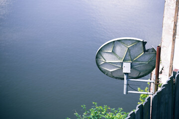 Satellite dish over river 