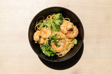 A bowl of prawn and broccoli spaghetti.