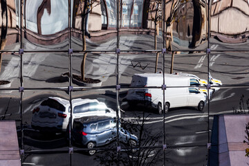 mirror reflection of car traffic on the building facade