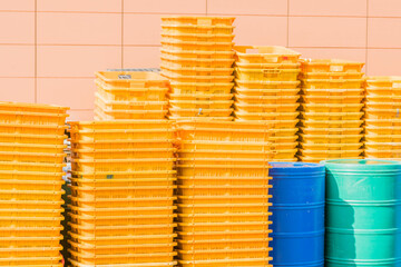 Yellow storage crates stacked against wall
