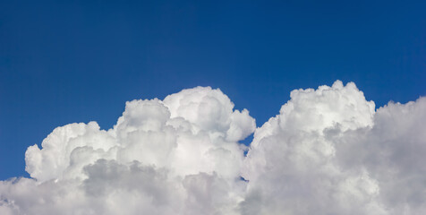 Blue skies with textured white clouds. A beautiful, atmospheric photograph.