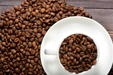 White coffee mug filled with coffee beans