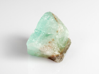 Green calcite on a white background. A common mineral. Ornamental stone.
