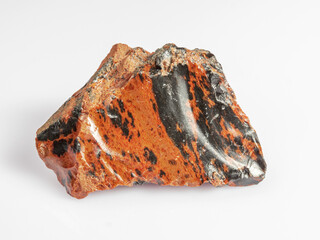 Obsidian mahogany. Igneous rock. White background. Magma glass.
