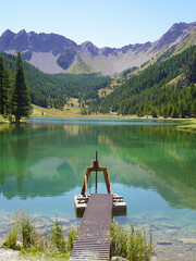 Obraz premium Lake Orceyrette with its pontoon and metal sluice gate. Briancon.