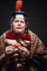 Overeating roman soldier with pizza against dark background