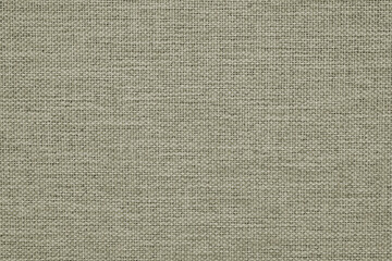 Close-up of gray-green woven surface. The texture is similar to len. Light abstract background from fabric. Textured braided generic gray backdrop. Macro