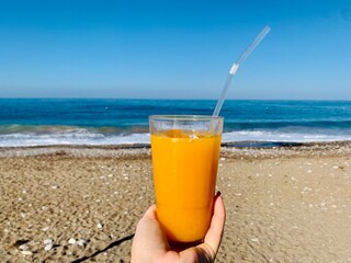 glass of orange juice on see background 