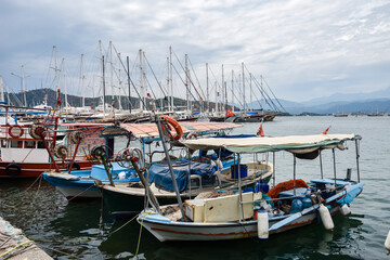 Yachts and boats in the harbor, Fethie, Turkey. The promenade of the city of Fethiye, boats are at bay in the blue waters of the Mediterranean. The resort town of Turkey.