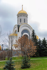 Beautiful Orthodox church in autumn nature. Religion and Faith. Vertical.