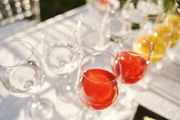 Table set for an event party or wedding reception. Banquet table design. Festive glasses with champagne and white wine.