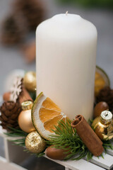 Christmas composition with candle in small sleigh.