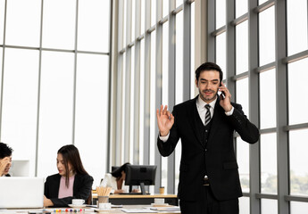 Young businessman talking on the phone. Discuss business and financial contract deals. Communication and conversation with stress. Reach of business agreement affects the operations of the company.