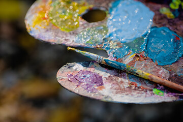 Shallow depth of field (selective focus) image with a painter color palette while painting a...