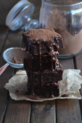 brownie, chocolate dessert in a column on a dark background