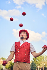 Man juggling balls in park