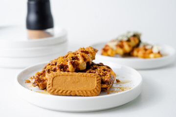 Croffle (a compound word of croissant and waffle) is a dessert where croissant raw paper is baked in a waffle pan and eaten with ice cream or maple syrup